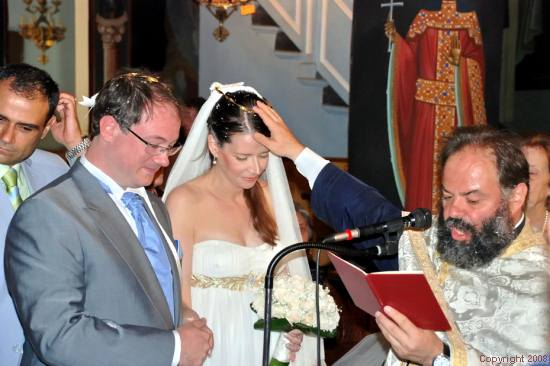 The Wedding - Greek Orthodox Priest blessing the bride and groom.